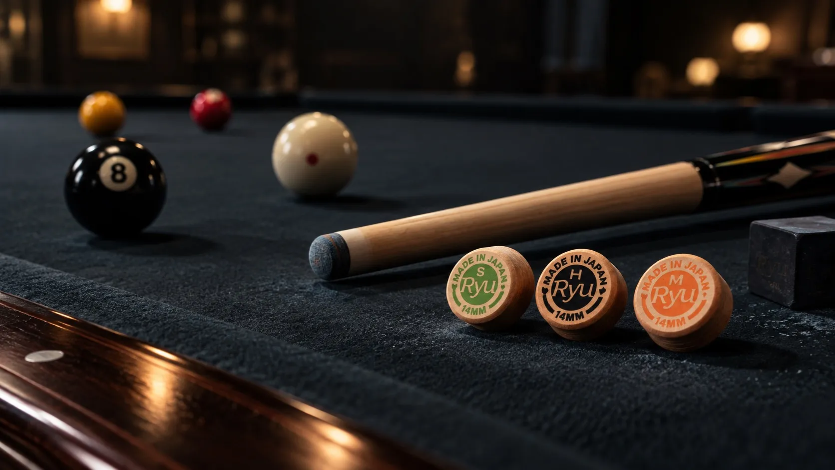 Ryu Tips H, M and S set beside a cue on the billiard table.